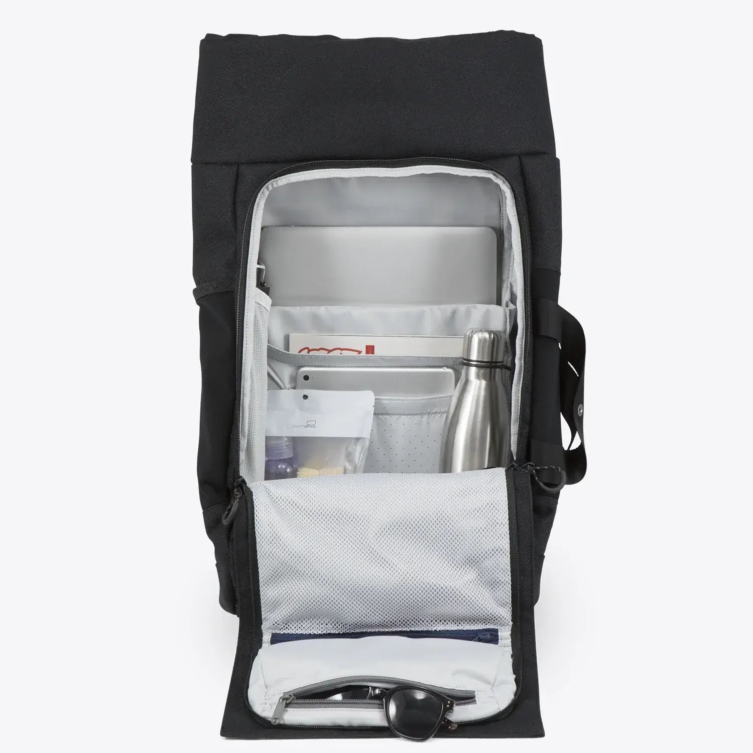 Interior view of the Blok Large Licorice Black Backpack showing compartments for laptop and accessories.
