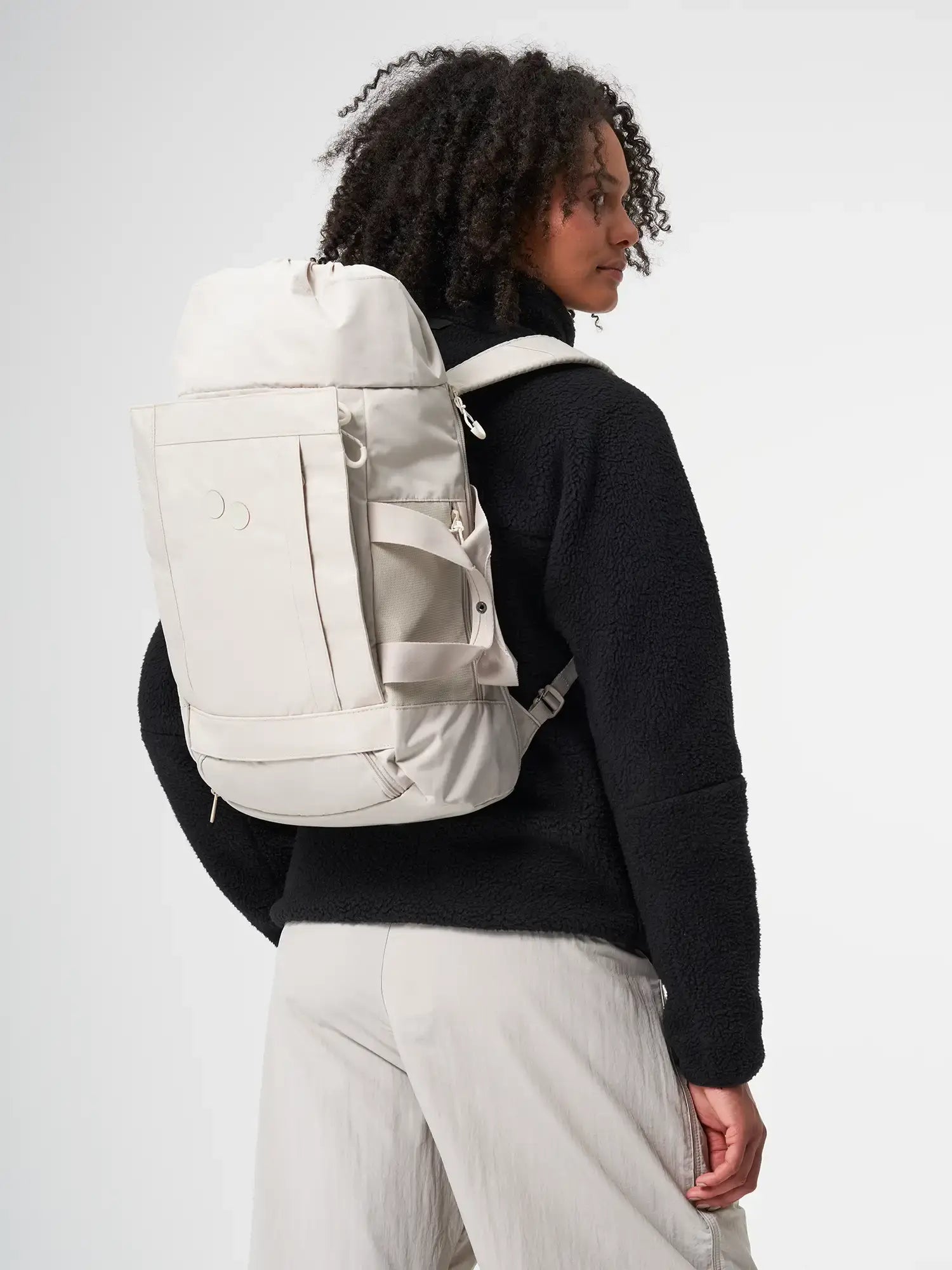 Blok Medium Cliff Beige Backpack worn by a person, showcasing the modern design and water-repellent material.