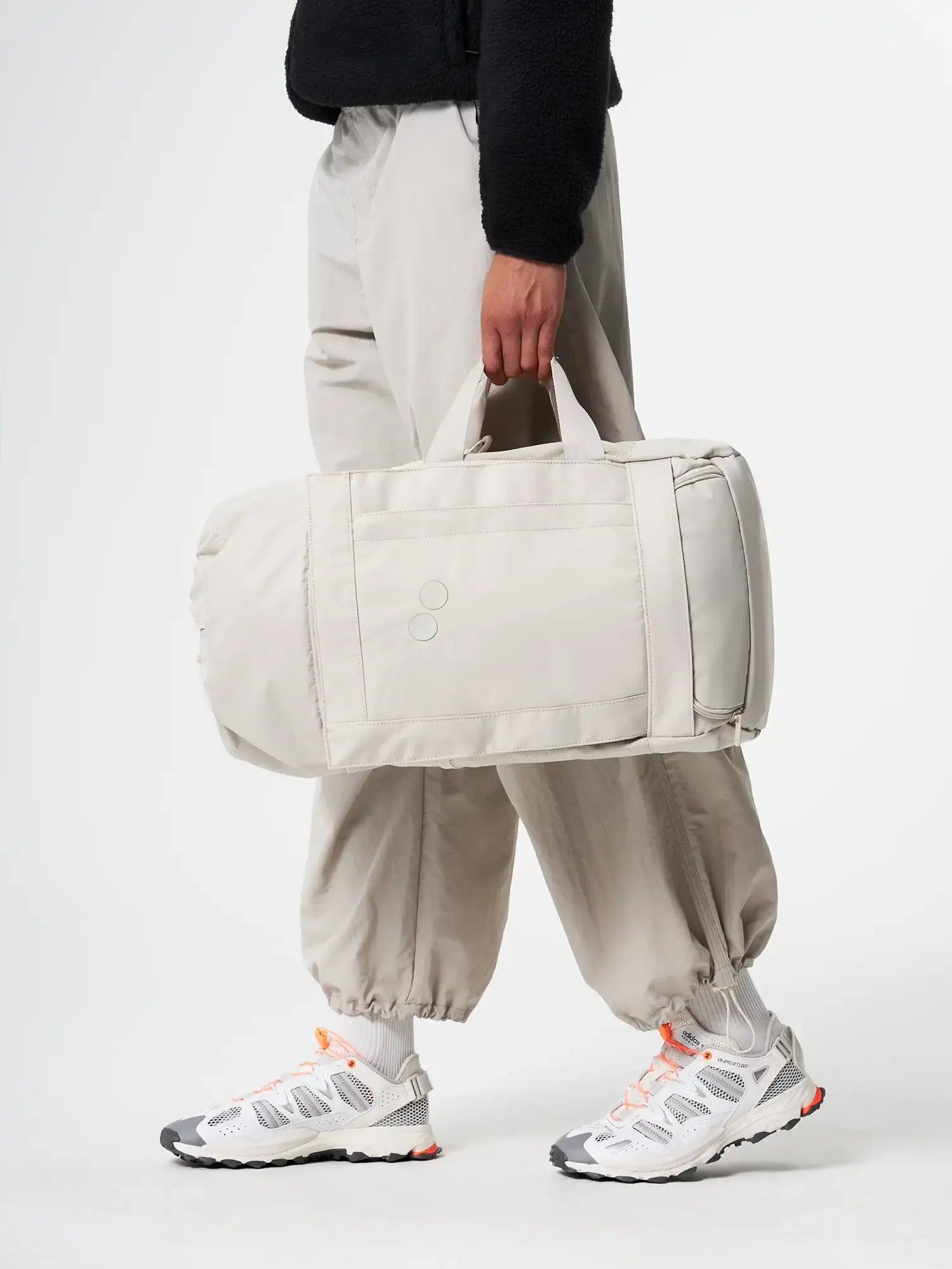 Blok Medium Cliff Beige Backpack being carried by a person in casual attire.