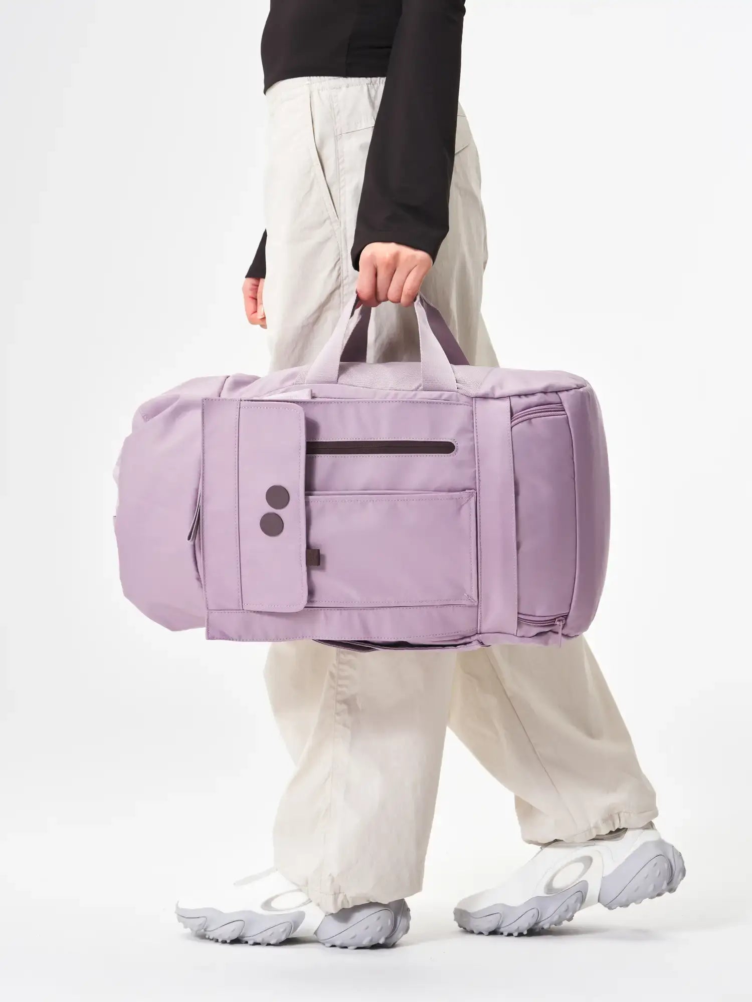 Blok Medium Construct Lilac Backpack being carried, showcasing its stylish design and functional pockets.