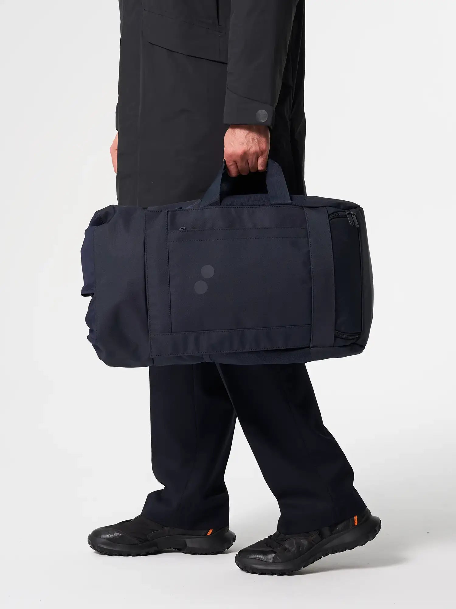 Blok Medium Fjord Navy Backpack shown being carried, featuring durable navy fabric and multiple compartments.