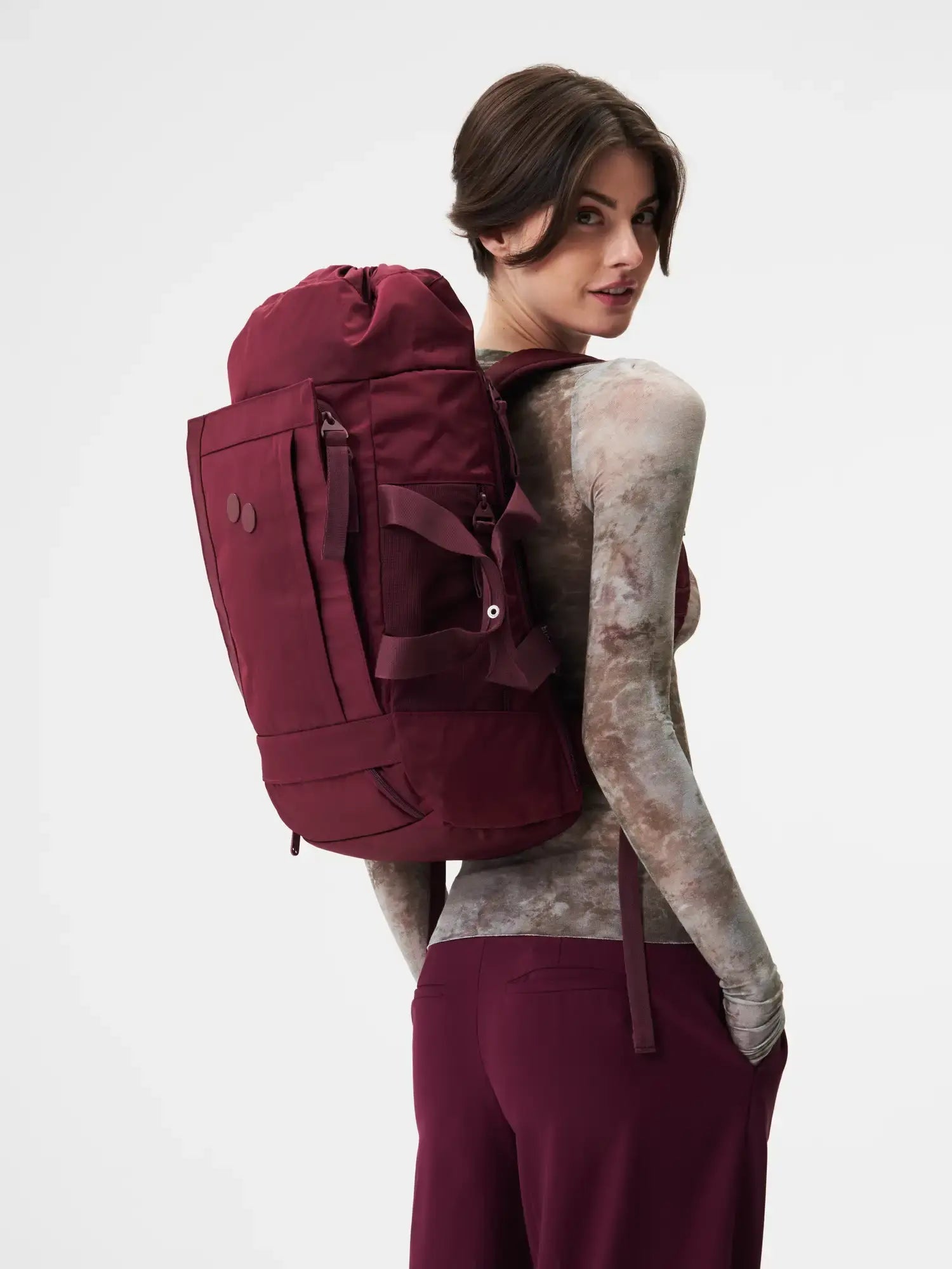 Blok Medium Glazed Red Backpack worn by a model, showcasing its stylish design and functionality.
