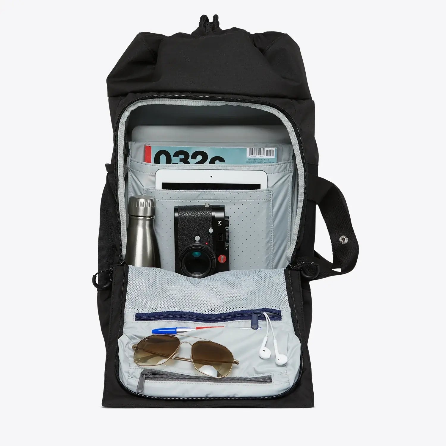 Interior view of the Blok Medium Rooted Black Backpack showcasing storage for a laptop, water bottle, and accessories.
