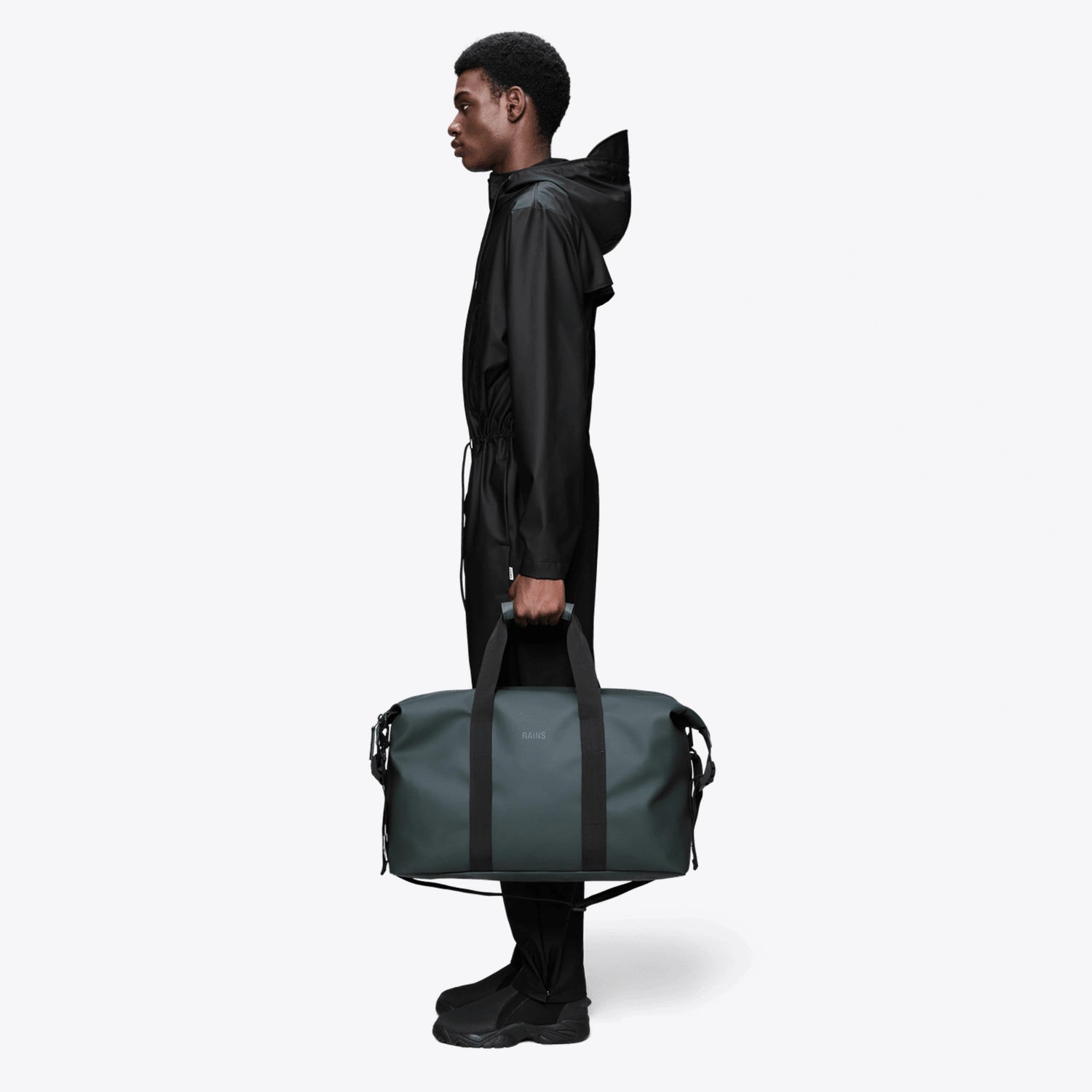 Weekend Bag Dark Grey held by a model, showcasing its waterproof design and large capacity.