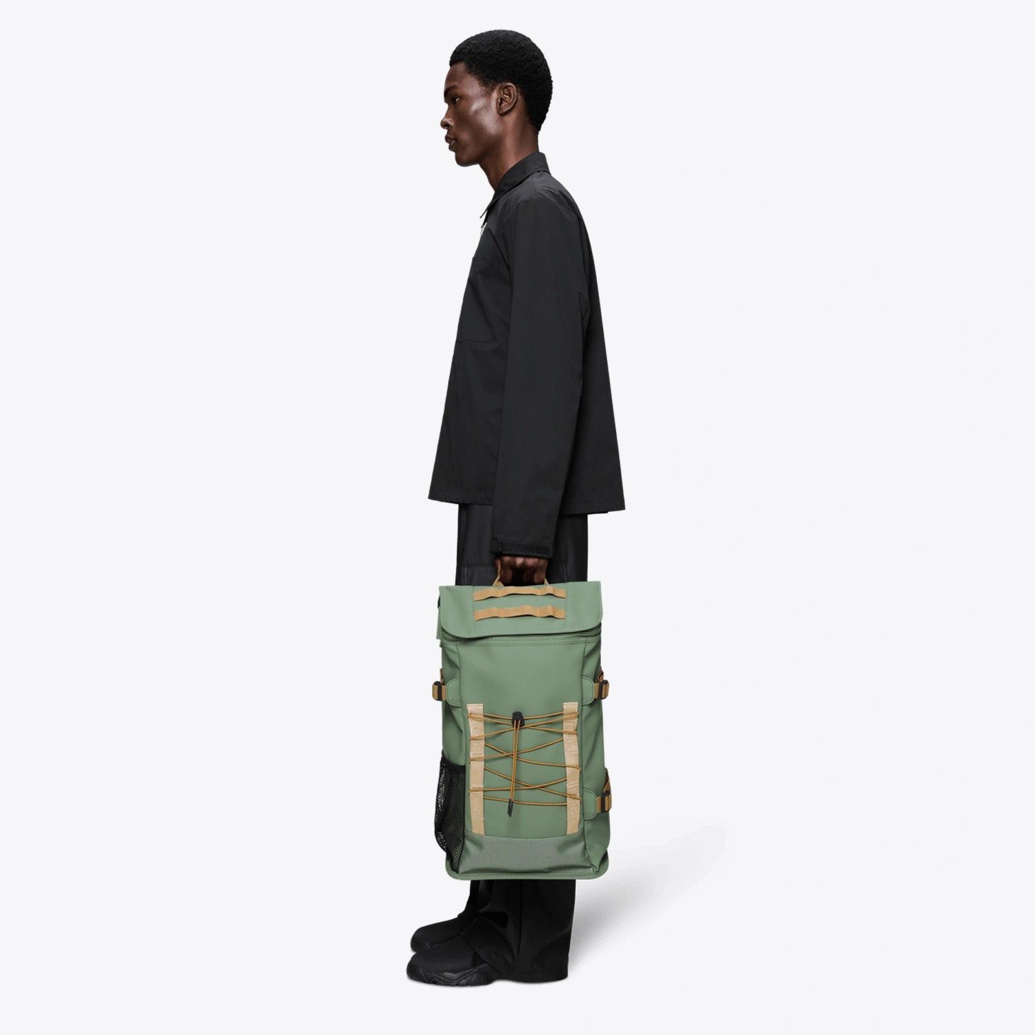 Trail Mountaineer Bag Well Backpack displayed by a model in profile, showcasing its stylish design and features.