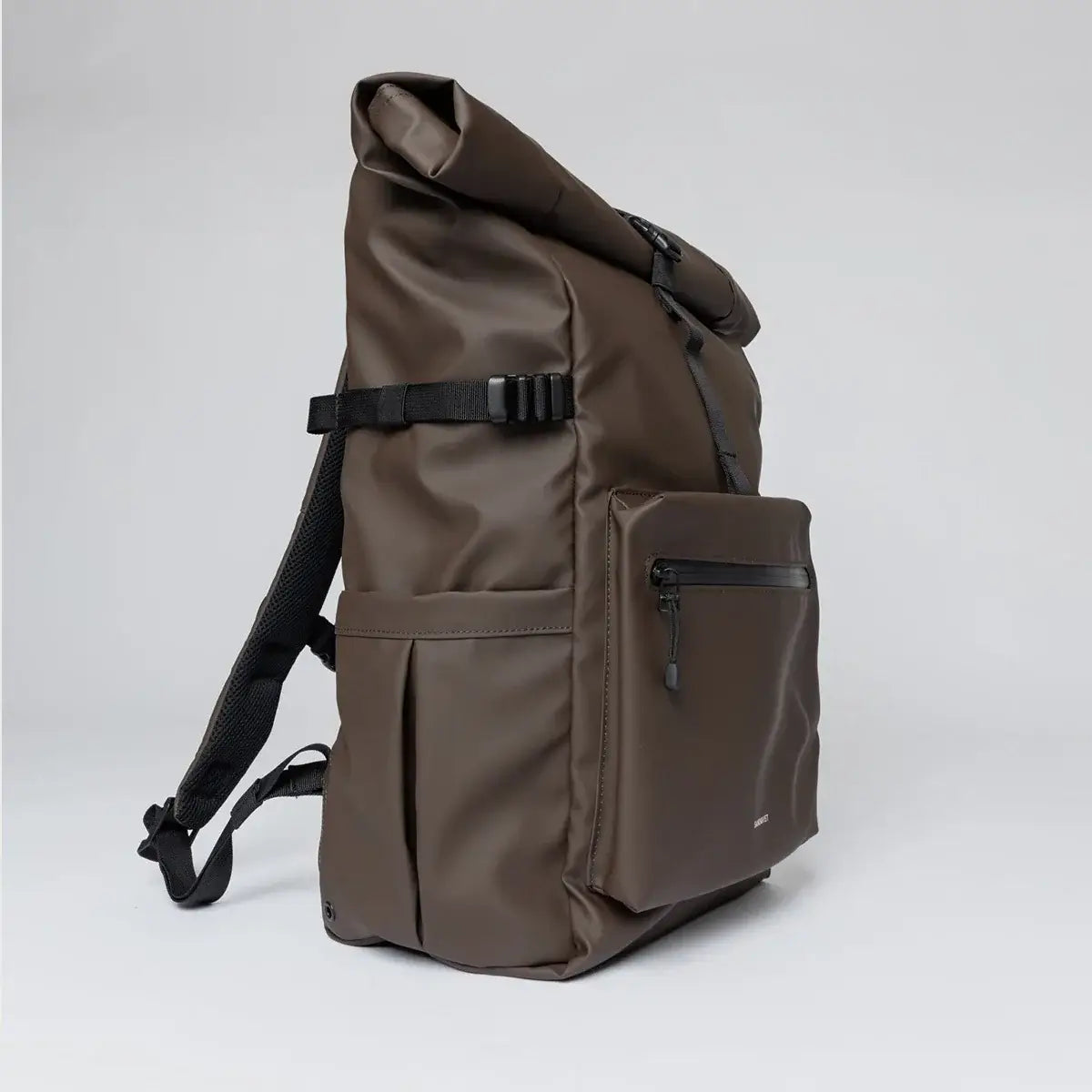 Stream Rolltop Backpack L Brown Backpack side view showcasing roll-top design and front zip pocket