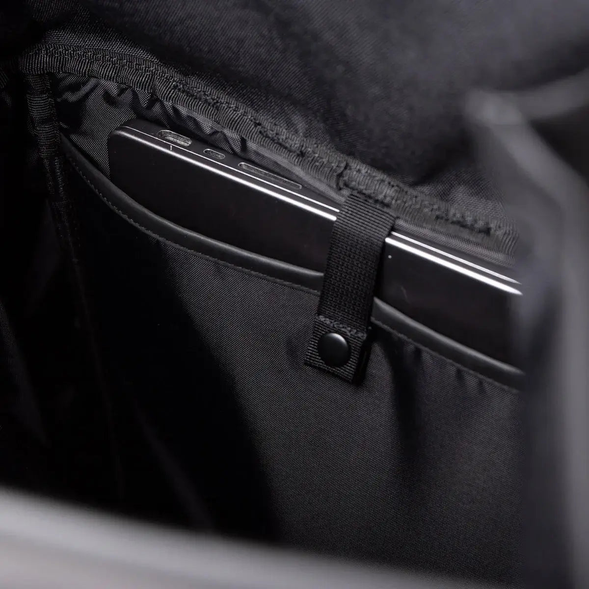 Stream Slim Rolltop L Black Backpack interior showing secure laptop compartment and padded lining.