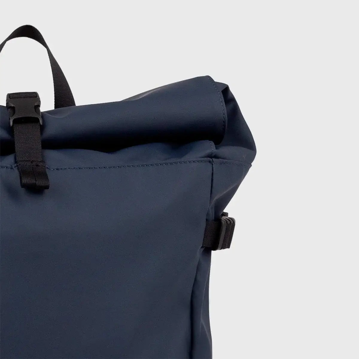 Stream Slim Rolltop L Navy Backpack close-up showing waterproof material and rolltop design.