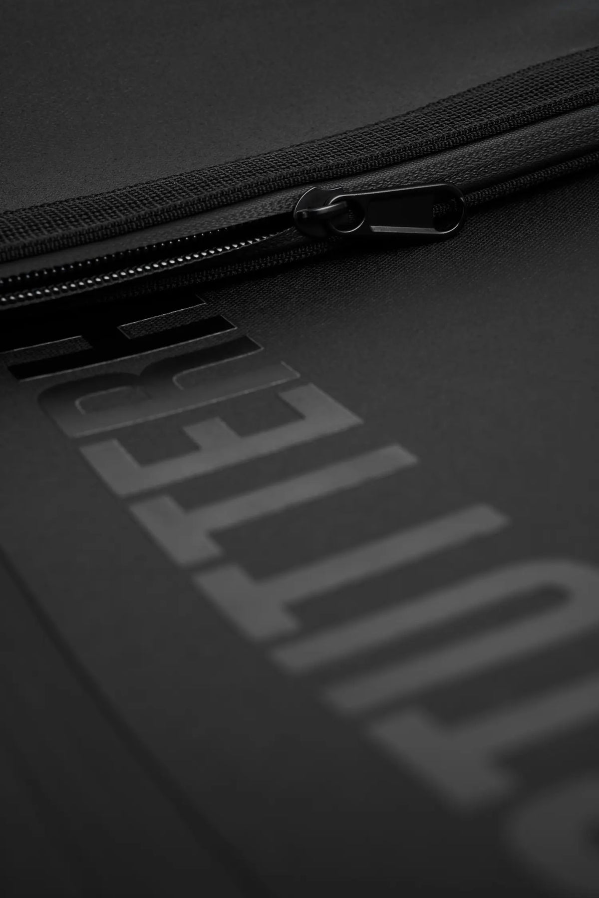 Close-up of the waterproof zipper on the Rain Rolltop 25L Black Backpack.