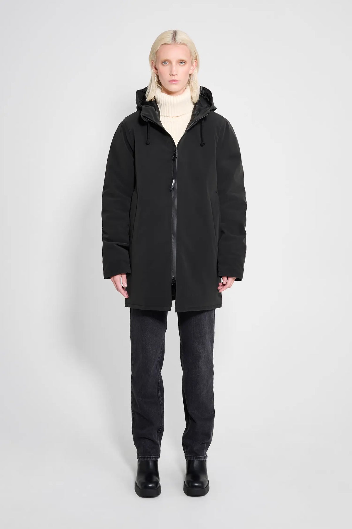 Model wearing the Stockholm Matte Black Winter Coat, showcasing its stylish oversized fit and adjustable hood.