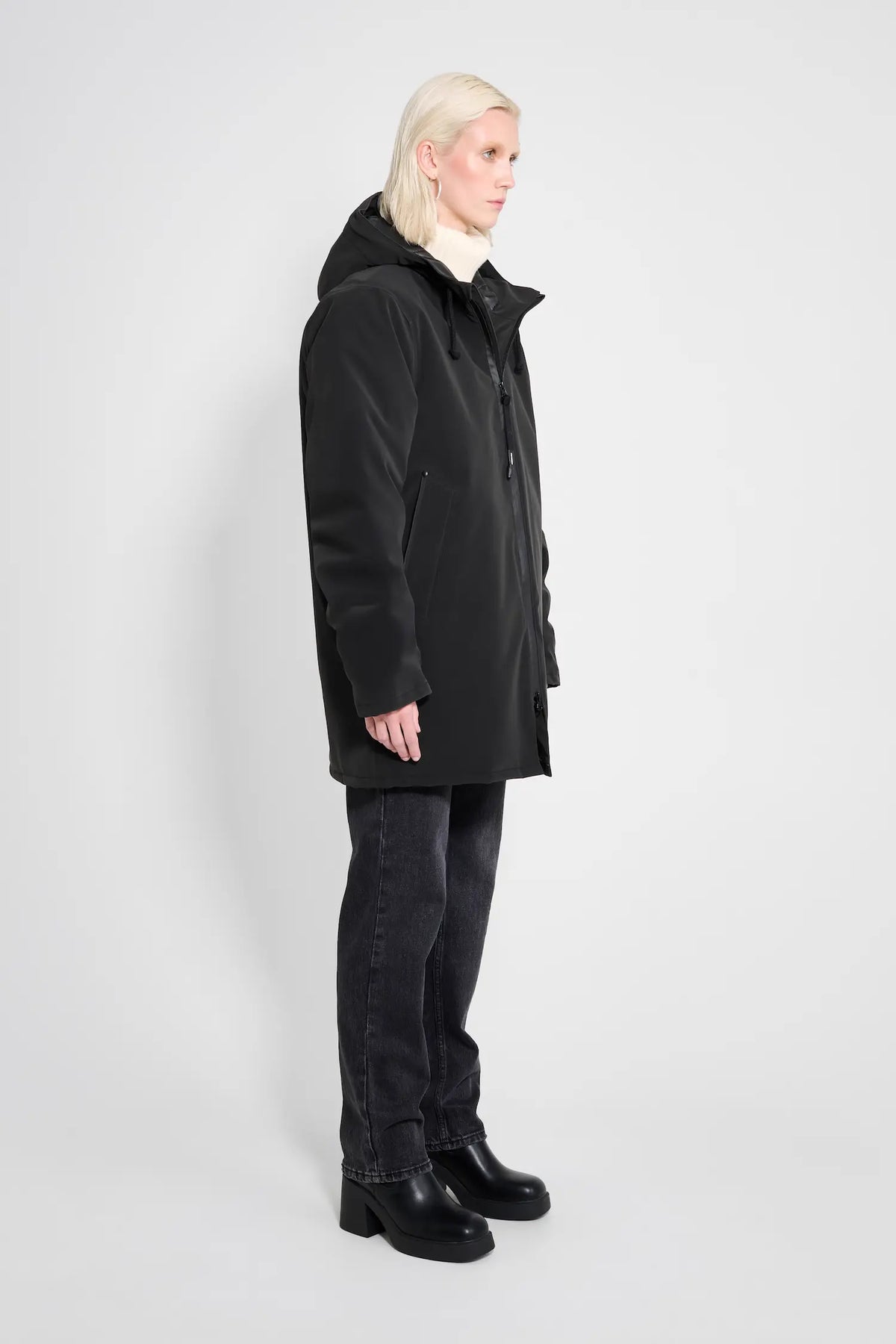 Stockholm Matte Black Winter Coat worn by model, showcasing its oversized fit and adjustable hood.