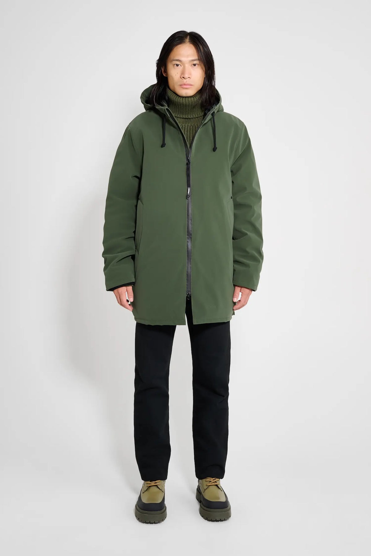 Stockholm Matte Green Winter Coat on model showcasing unisex oversized fit and adjustable drawstring hood.