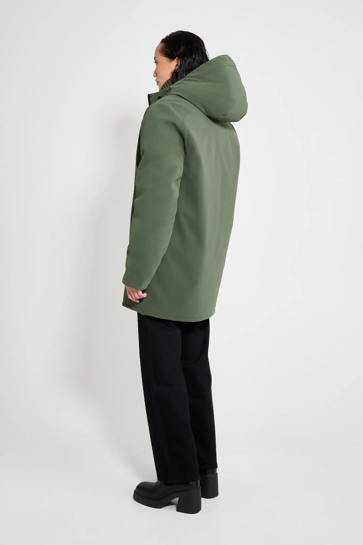 Stockholm Matte Green Winter Coat worn from behind, showcasing the adjustable drawstring hood and oversized fit.
