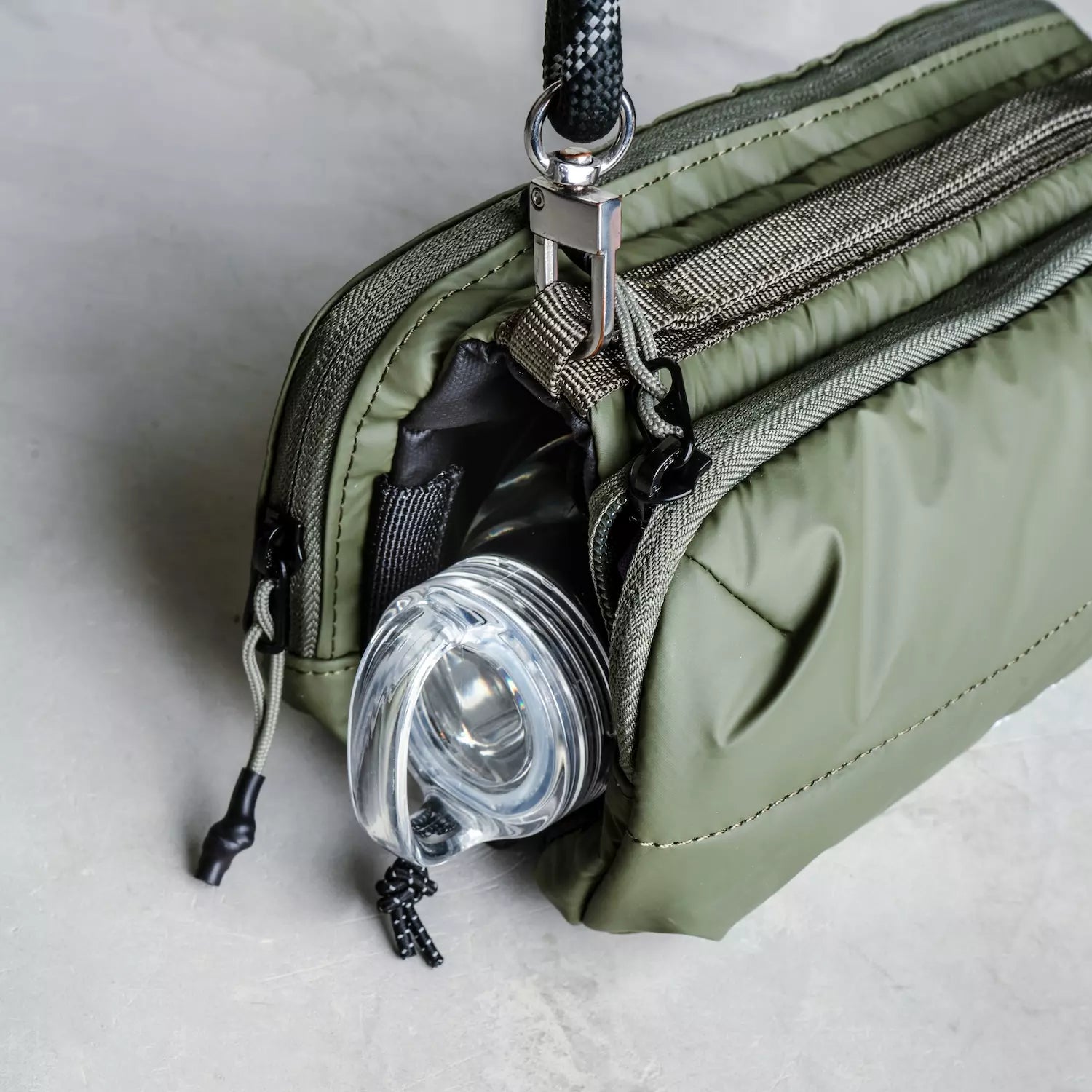 Bottle Sacoche Medium Blue Check Wool Bag showcasing water repellent fabric and compartment for a bottle.