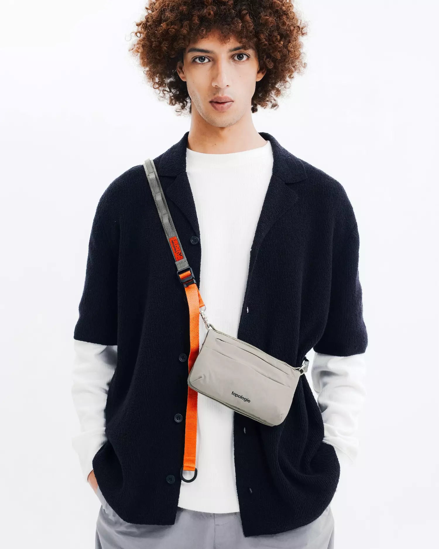 Phone Sacoche 90 Purple Washed Silk Nylon Bag worn by a model, showcasing stylish design and functionality.