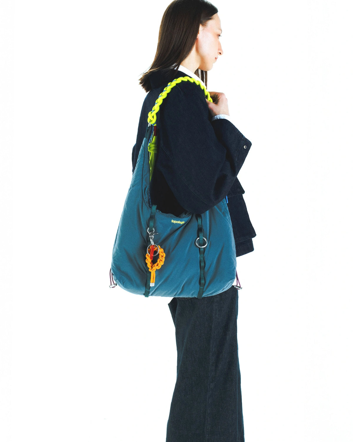 Model showcasing the 8.0mm Braided O-Rope Swamp on a stylish bag, featuring adjustable strap and vibrant colors.