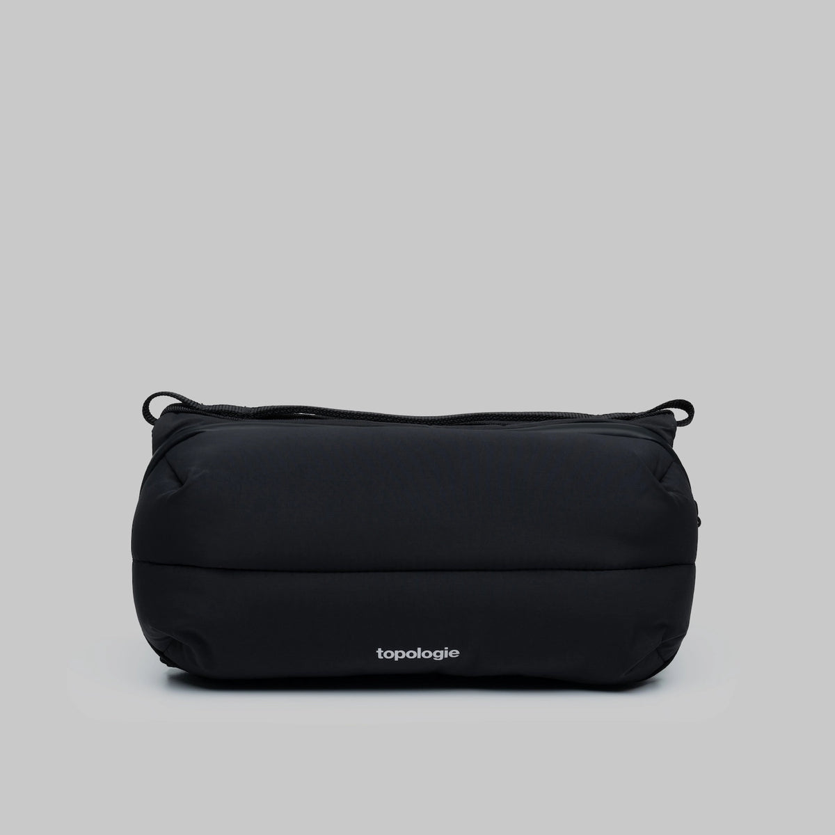 Bottle Sacoche Medium Black Silky Peach Bag in sleek black fabric with Topologie branding.