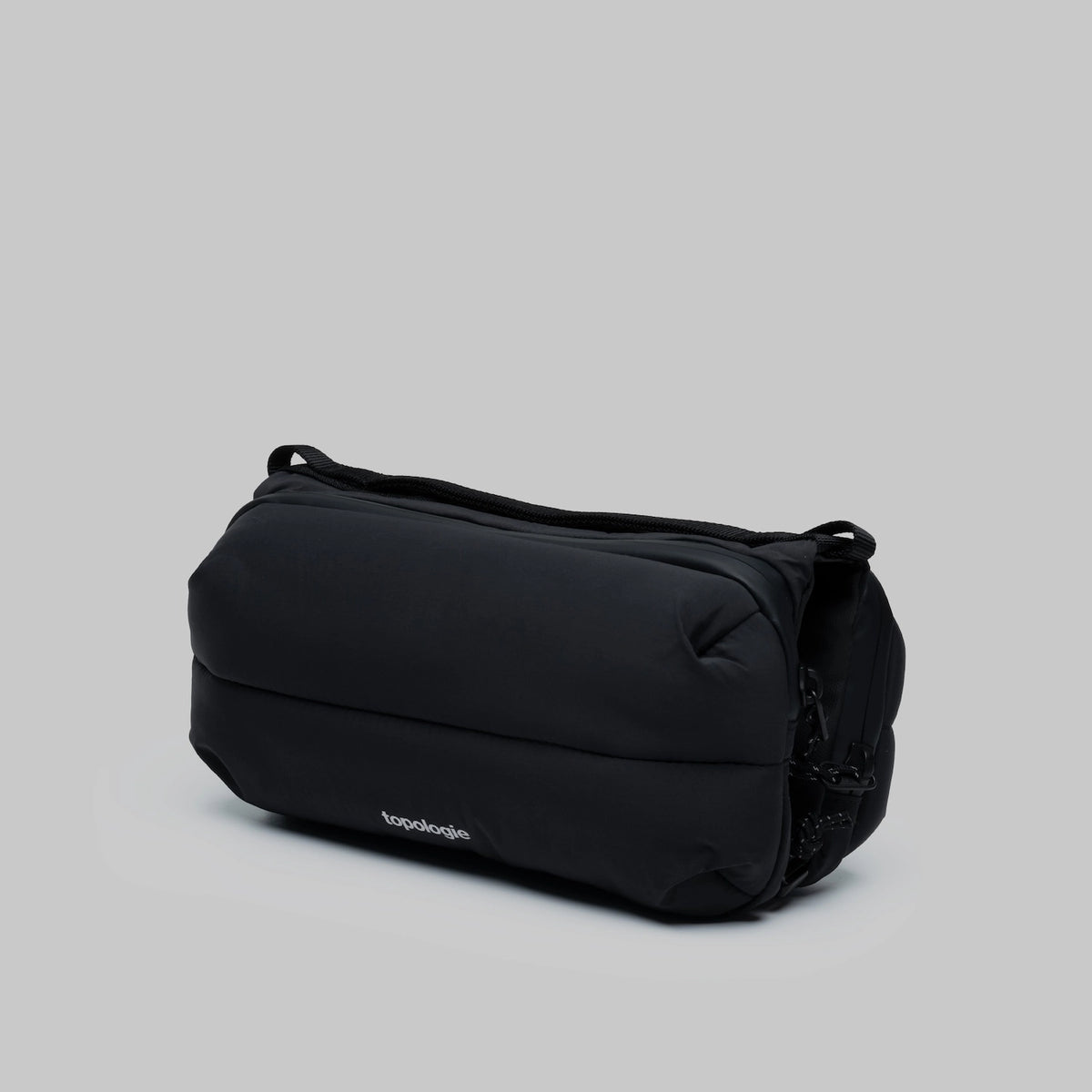 Bottle Sacoche Medium Black Silky Peach Bag in black with sleek design for carrying bottles.