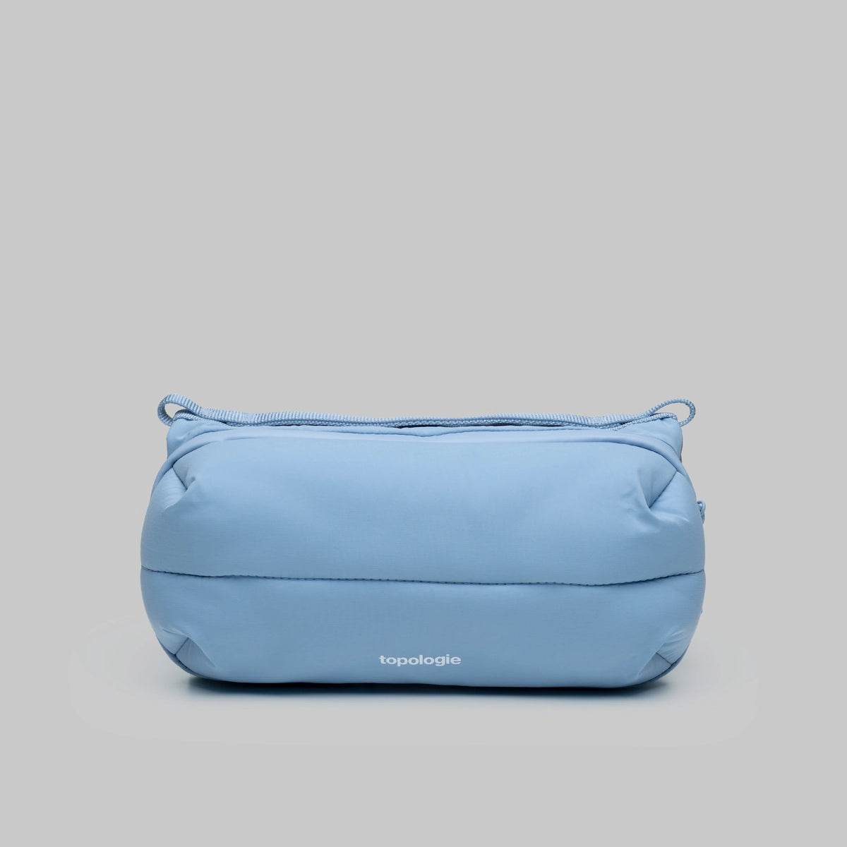 Bottle Sacoche Medium Chambray Silky Peach Bag in a light blue color with a sleek design.