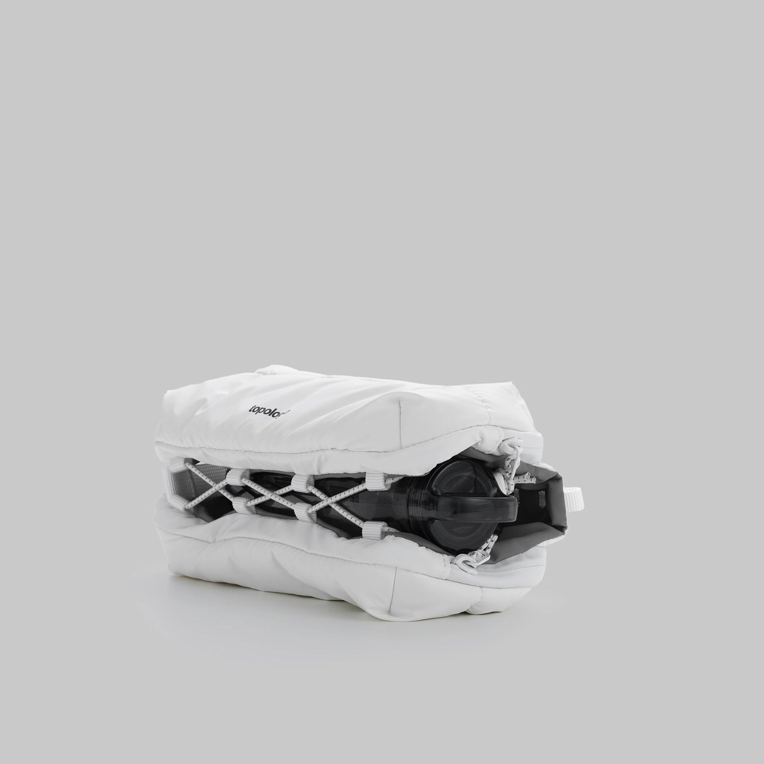 Bottle Sacoche Medium Ecru Matt Coated Bag shown folded with a bottle inside.