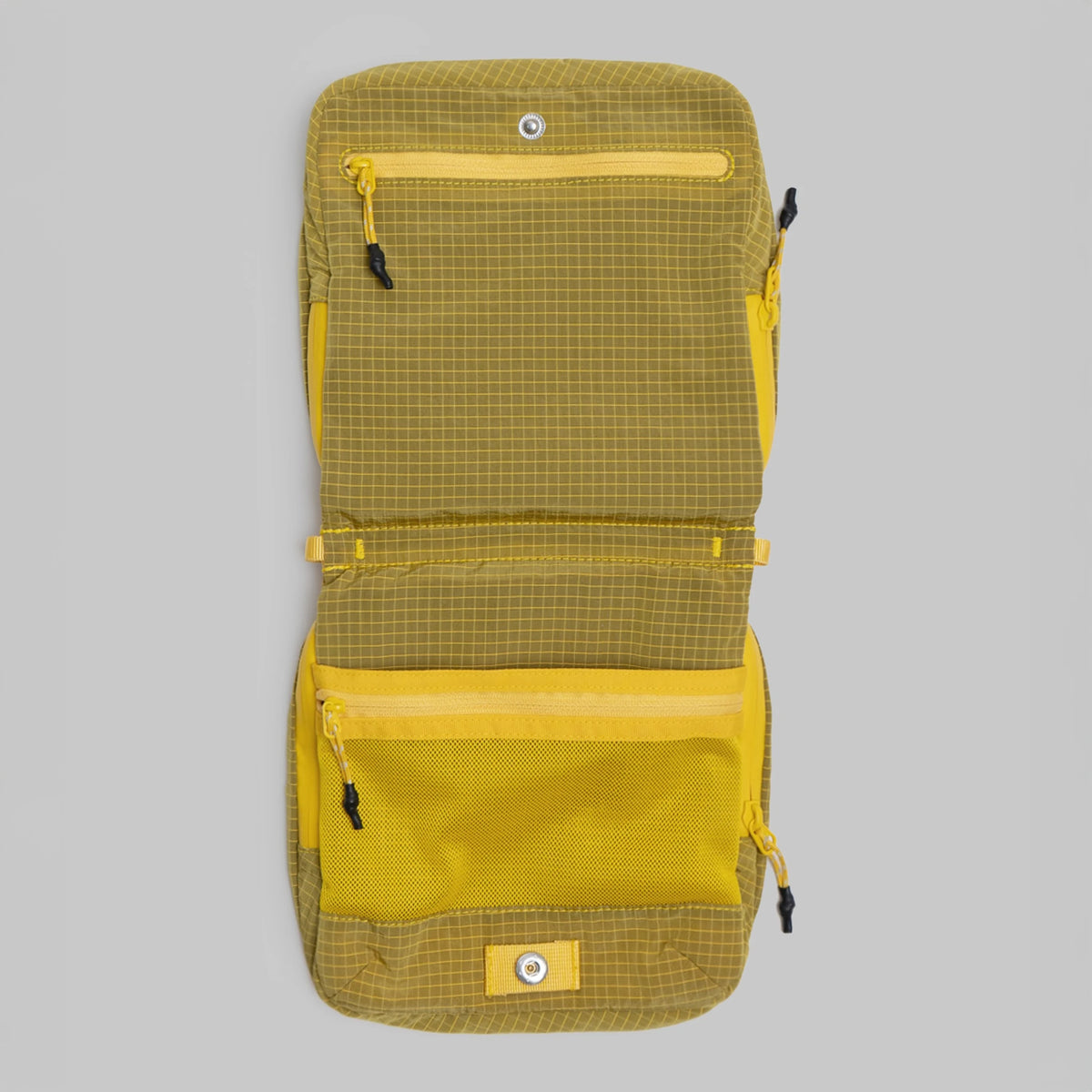 Cassette Sacoche Medium Mustard Vintage Ripstop Bag open showing zippered compartments and mesh pockets.