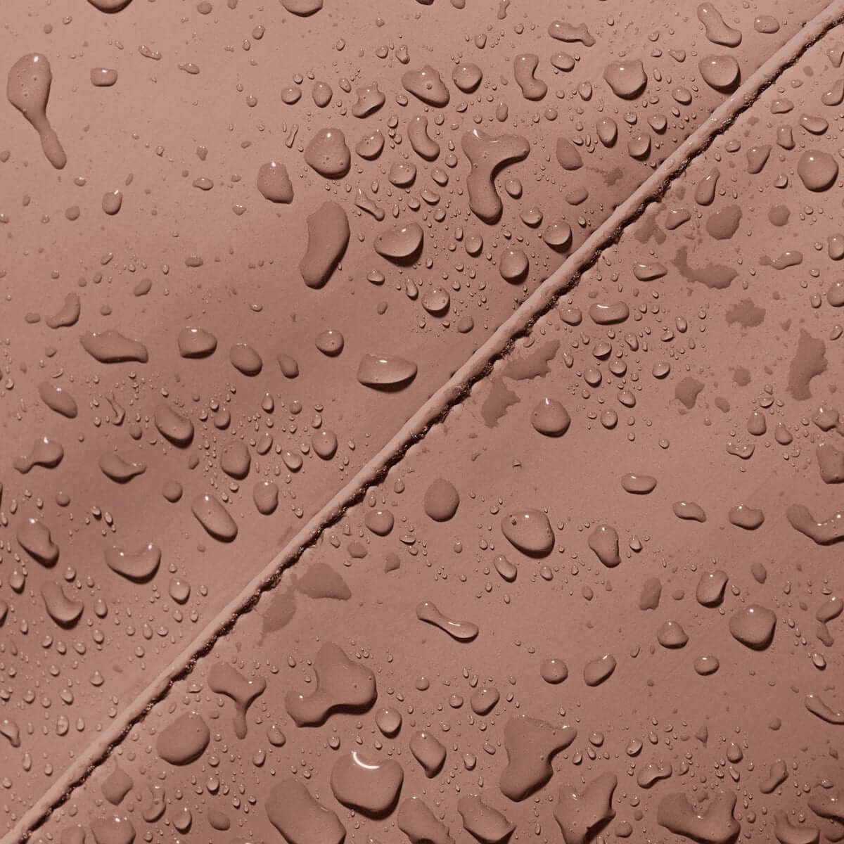 Waterproof material detail of Hajo Macro Lotus Redwood Backpack with water droplets.
