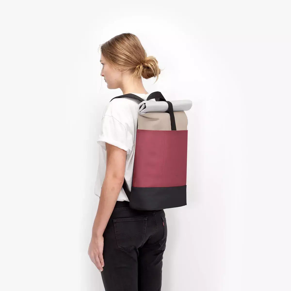 Hajo Lotus Infinity Sand Burgundy Backpack worn by a model showcasing its sleek design and colors.