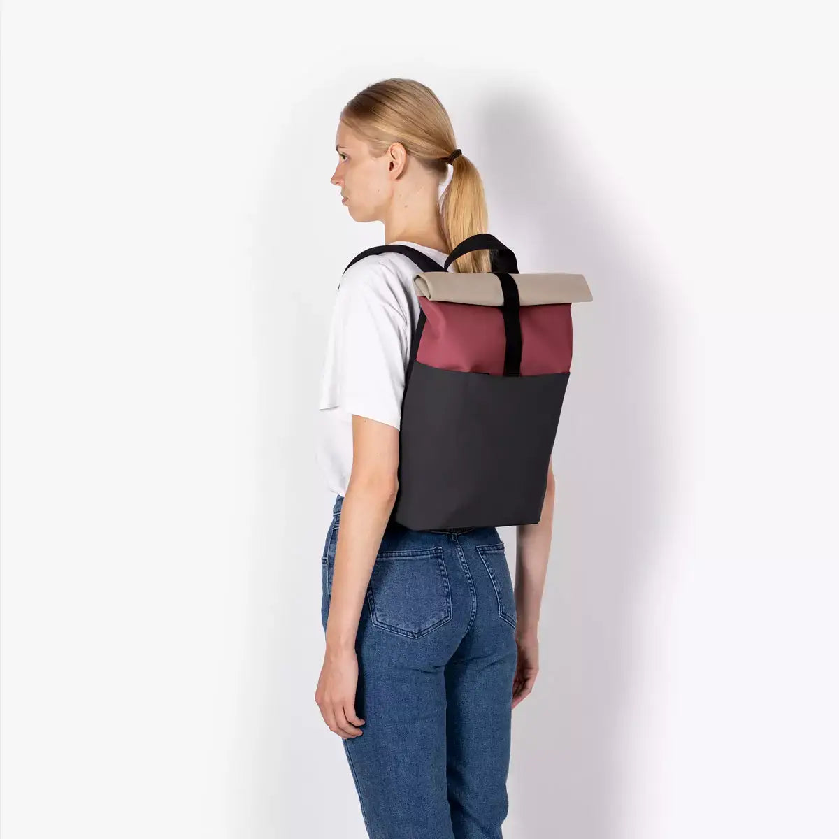 Hajo Mini Lotus Infinity Burgundy Black Backpack on a woman, showcasing its stylish design and durability.