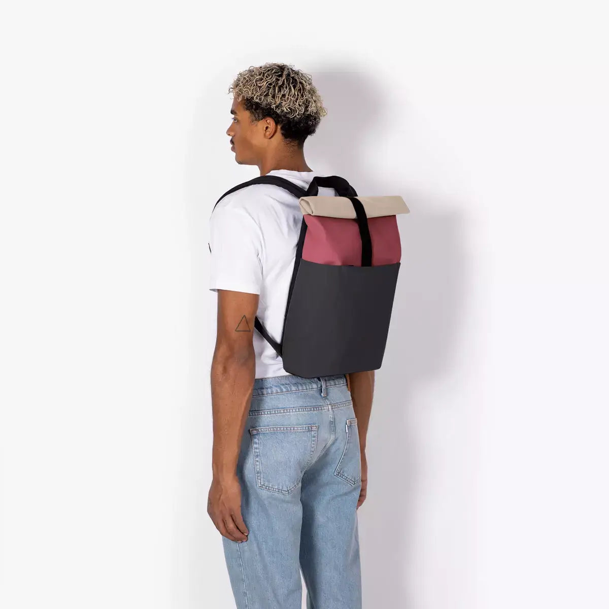 Hajo Mini Lotus Infinity Burgundy Black Backpack on model's back showcasing modern design and functionality.