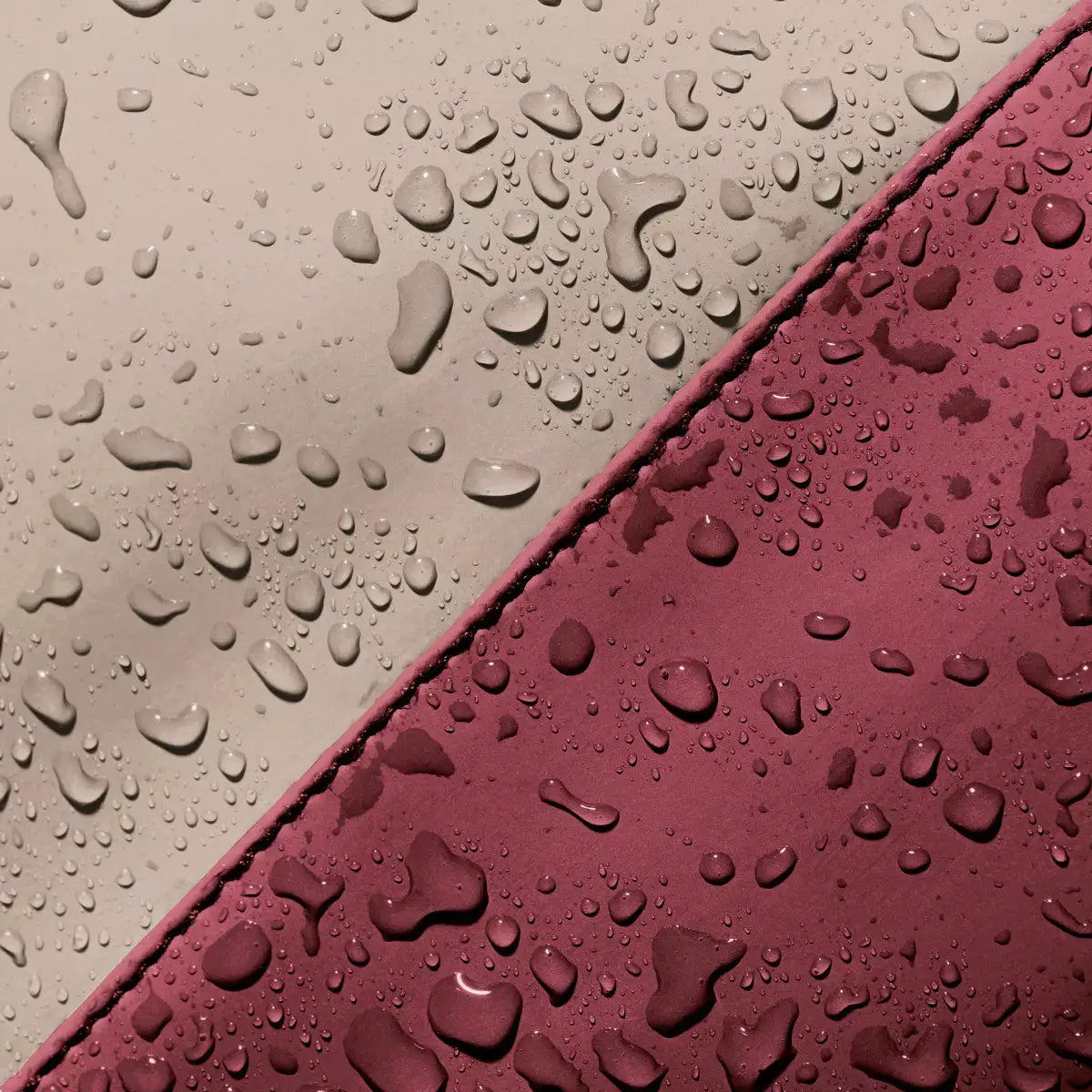 Close-up of water droplets on Hajo Mini Lotus Infinity Sand Burgundy Backpack showcasing its waterproof material.