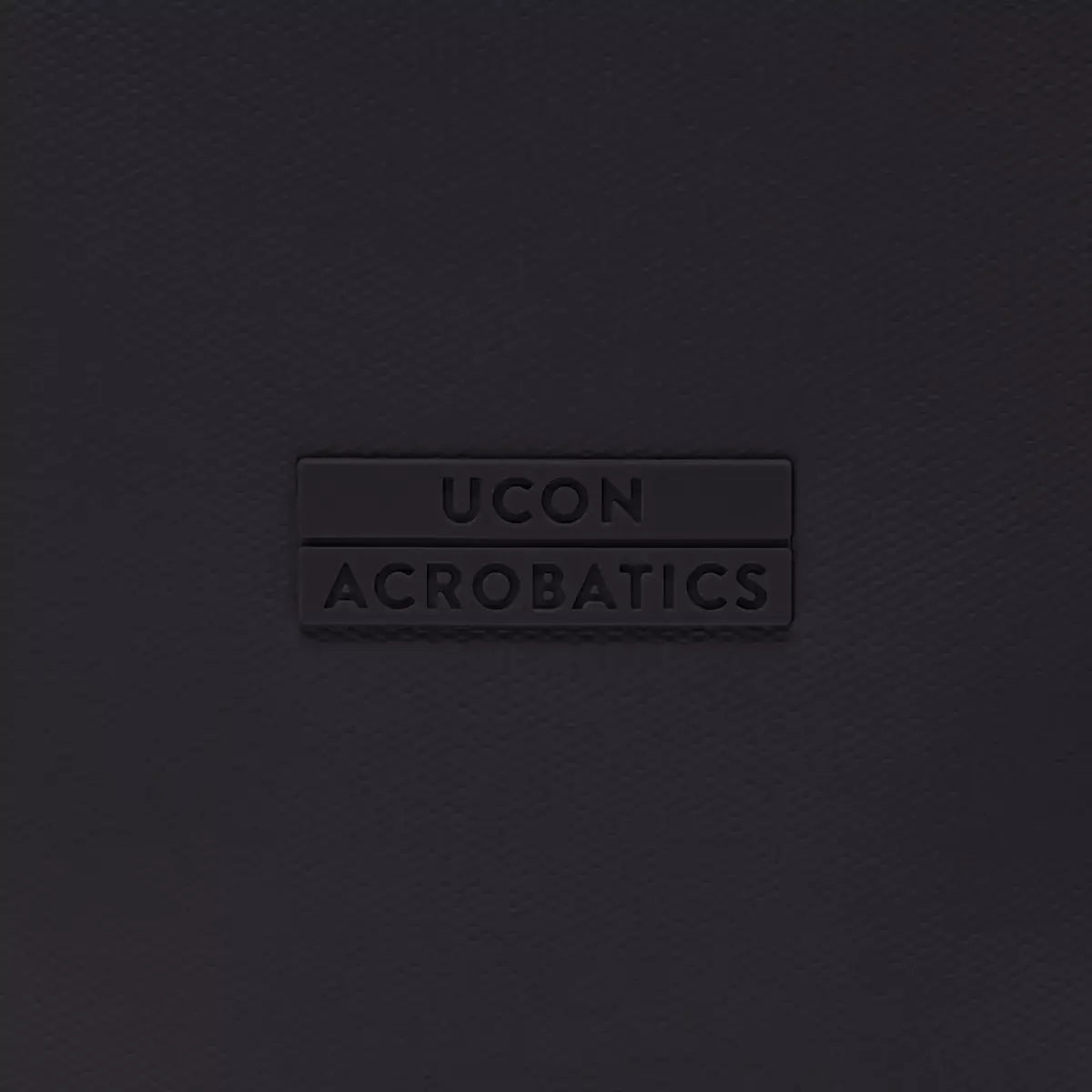 UCON Acrobatics logo on a sleek black surface, showcasing stylish and modern design.