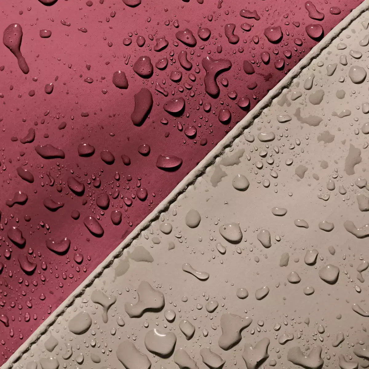 Close-up of the waterproof material featuring droplets on Jannik Medium Lotus Infinity Burgundy Sand Backpack.
