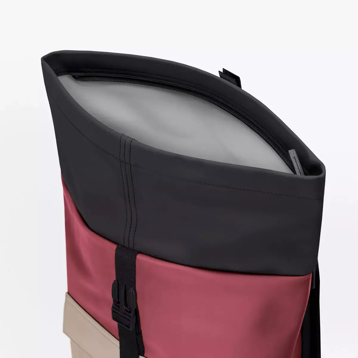Close-up of the roll-top closure of the Jannik Medium Lotus Infinity Burgundy Sand Backpack.