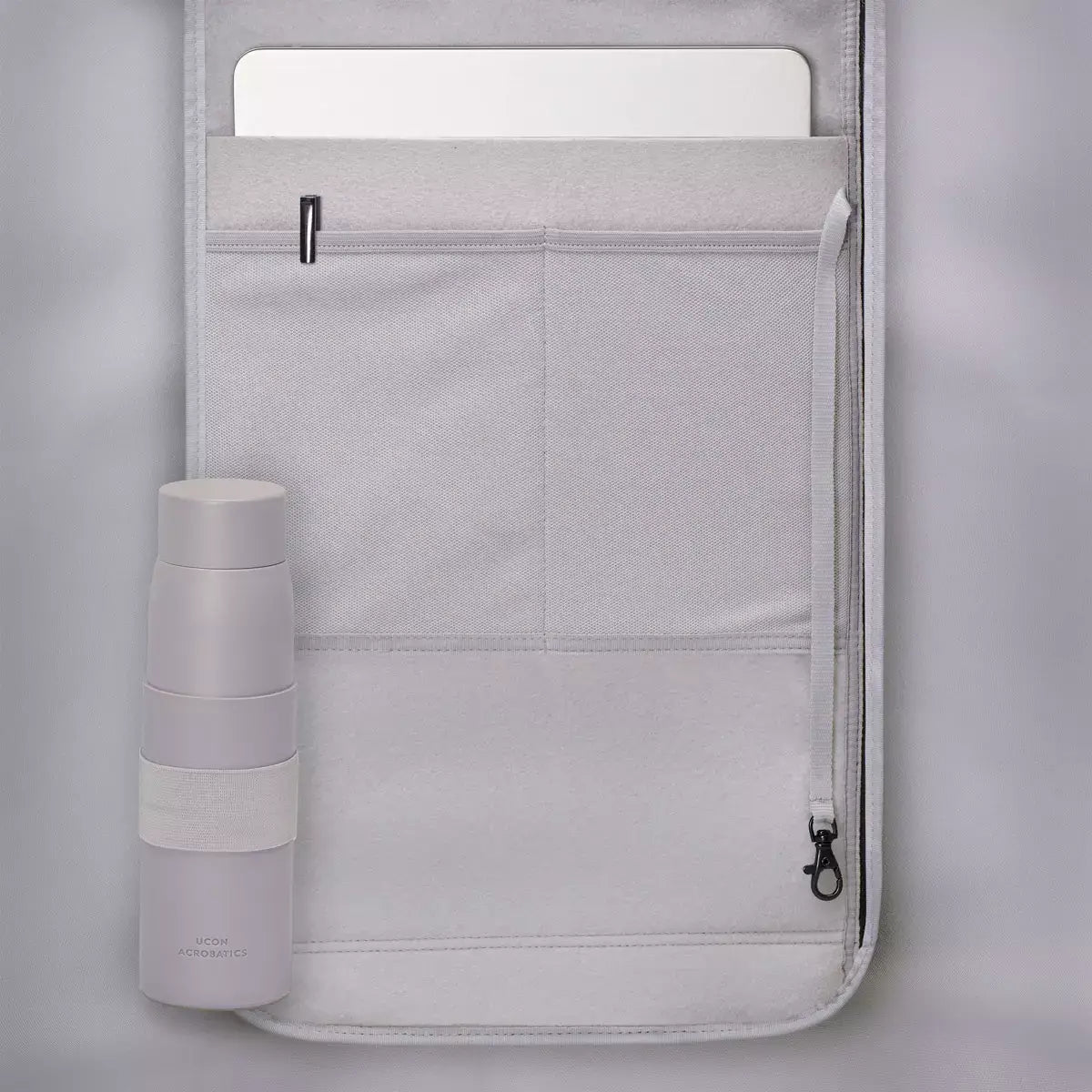 Interior view of Jannik Medium Lotus Infinity Burgundy Sand Backpack showcasing laptop compartment and water bottle.