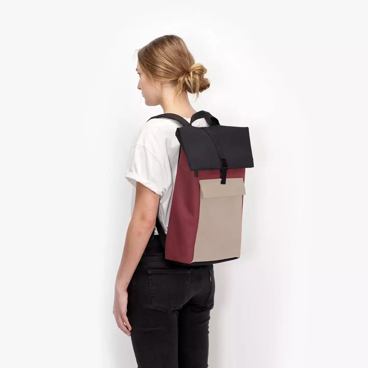 Jannik Medium Lotus Infinity Burgundy Sand Backpack worn by a model, showcasing its stylish design and functionality.