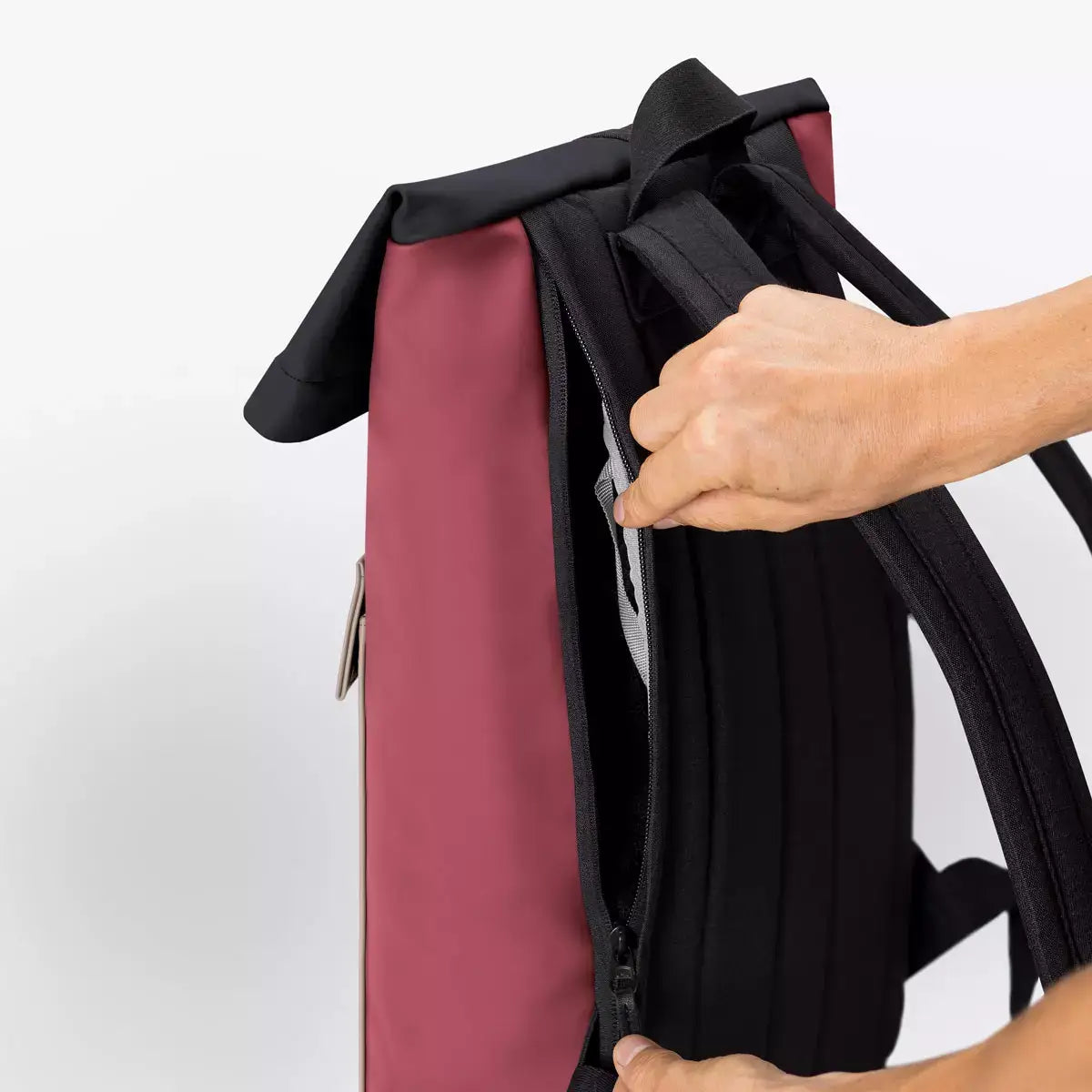 Jannik Mini Lotus Infinity Burgundy Sand Backpack showing interior zipper pocket and roll-top design.