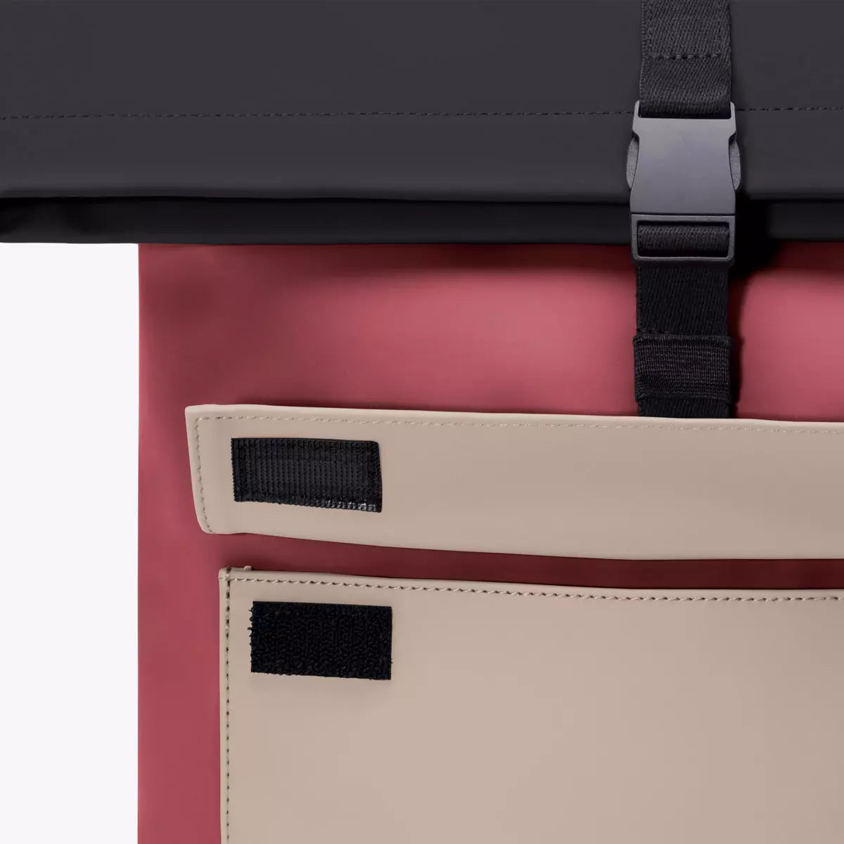 Jannik Mini Lotus Infinity Burgundy Sand Backpack roll-top closure detail with clip and side zipper pockets.