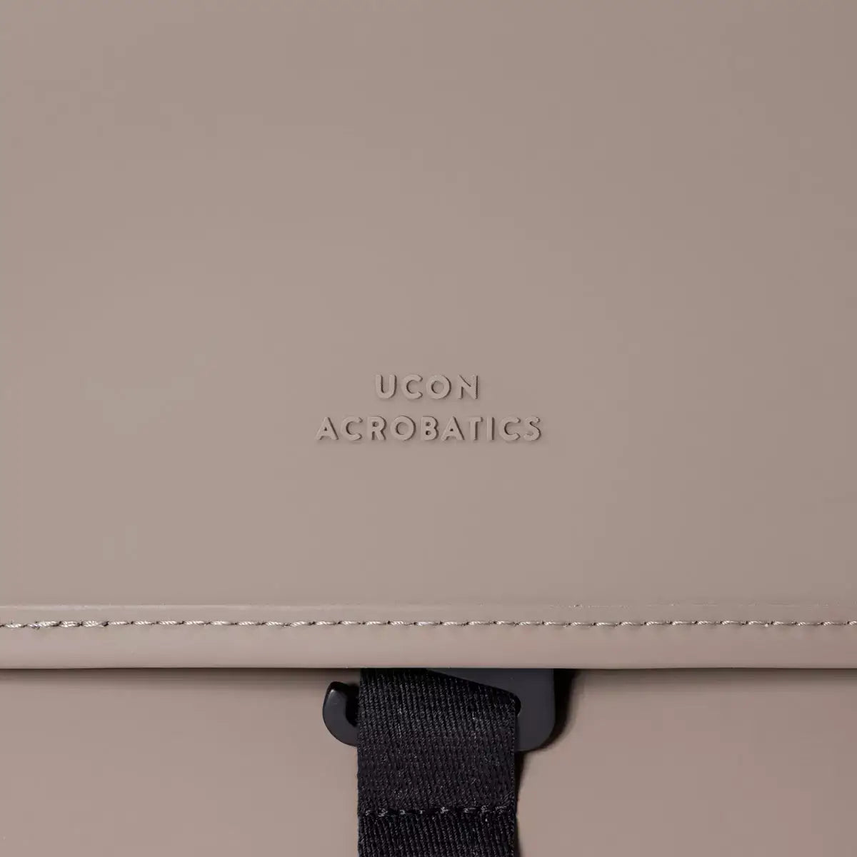 Katsu Lotus Infinity Dark Sand Shoulder Bag detail with UCON Acrobatics logo on the soft material.