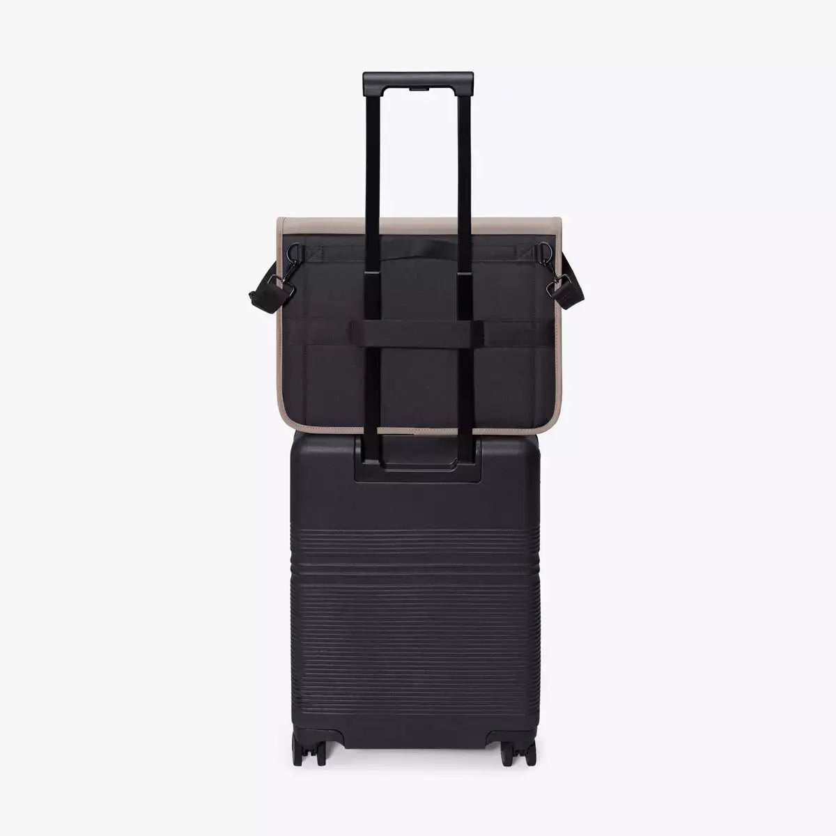 Katsu Lotus Infinity Dark Sand Shoulder Bag atop a black trolley, showcasing its versatile travel features.