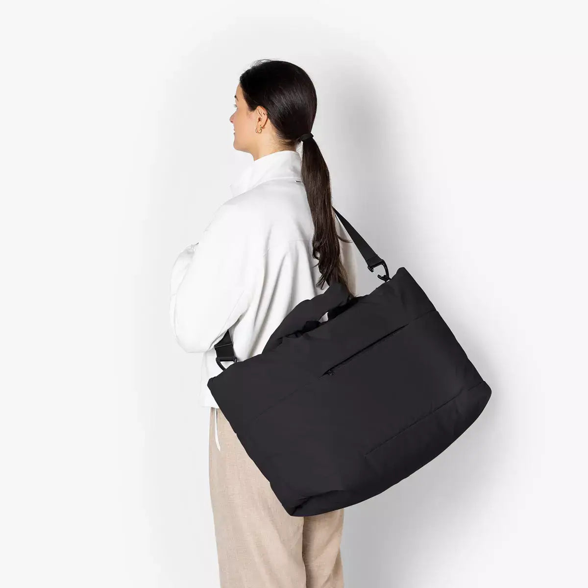 Olivia Large Moss Black Shoulder Bag worn over the shoulder, showcasing its large size and sleek design.