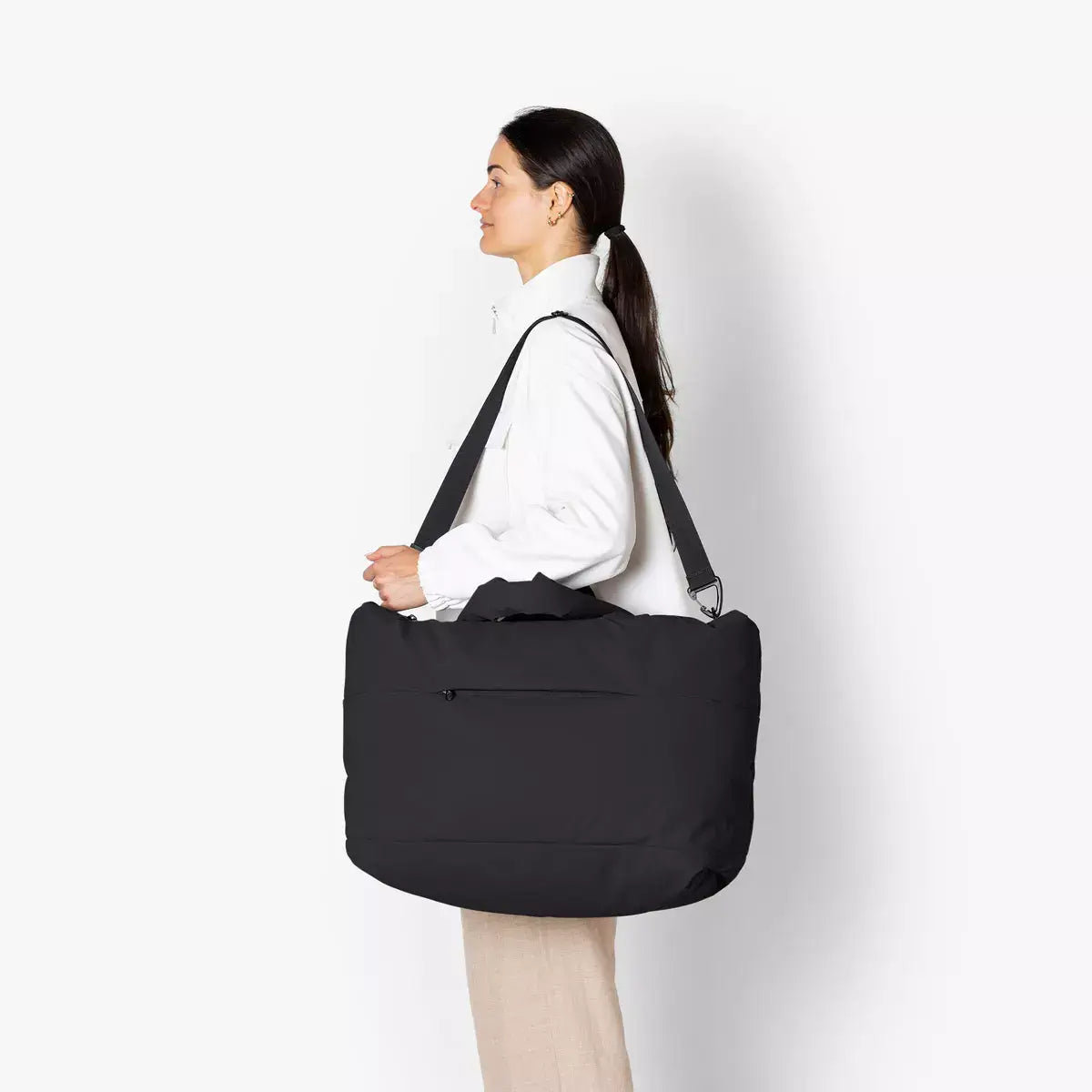 Olivia Large Moss Black Shoulder Bag worn by a woman, showcasing its stylish design and versatility in a side view.