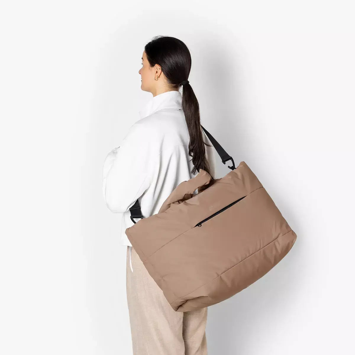 Olivia Large Moss Earth Shoulder Bag worn on shoulder by model in neutral outfit