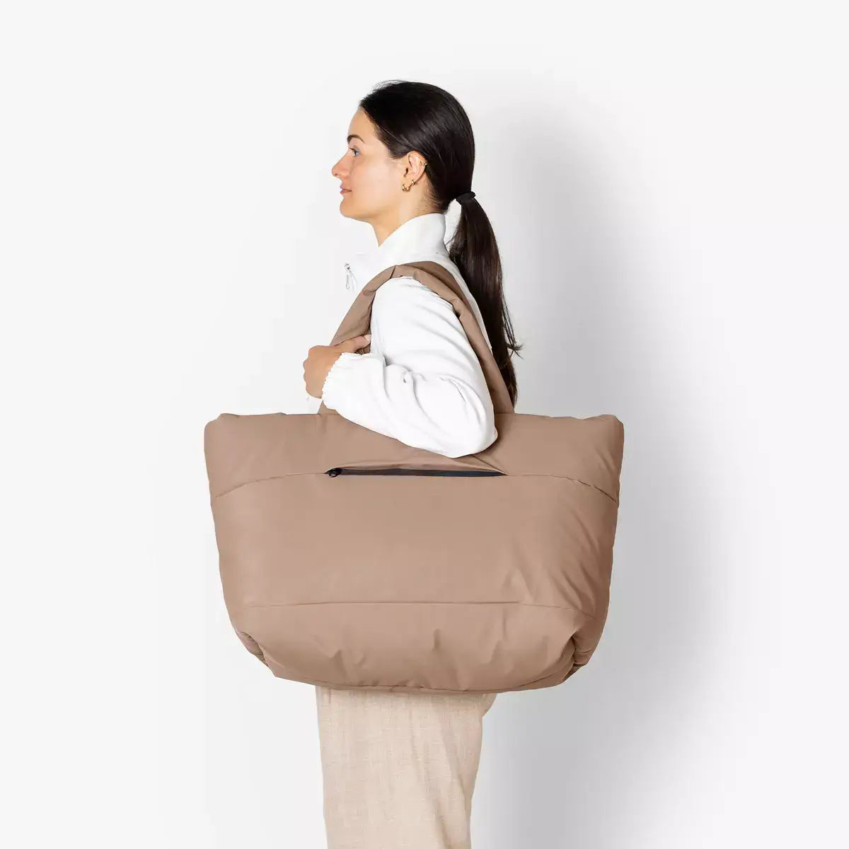 Olivia Large Moss Earth Shoulder Bag displayed on a woman, showcasing its spacious design and stylish look.