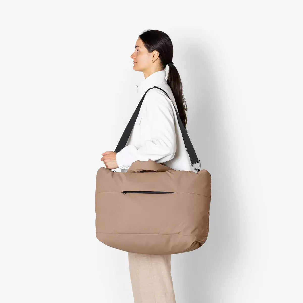 Olivia Large Moss Earth Shoulder Bag being carried by a model, showcasing its spacious design and adjustable strap.