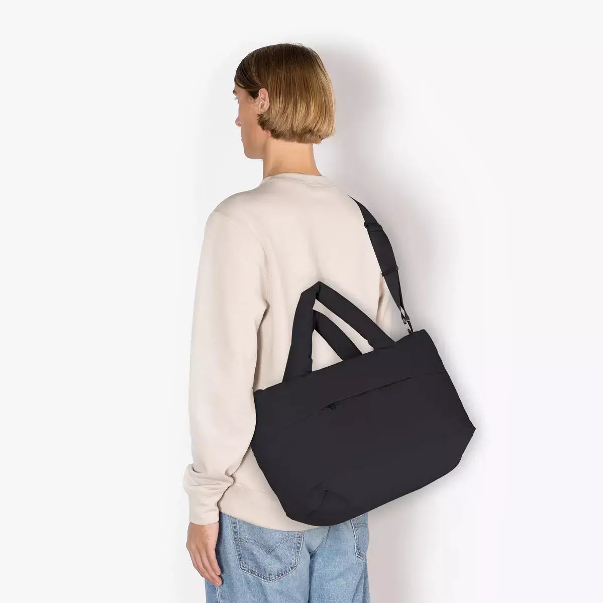 Olivia Medium Moss Black Shoulder Bag worn by a model from behind, showcasing its stylish design and adjustable straps.