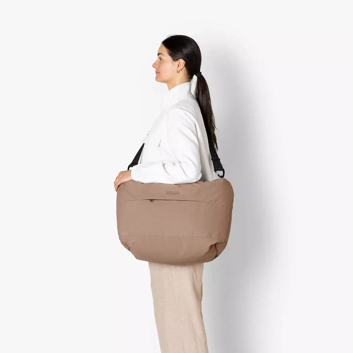 Olivia Medium Moss Earth Shoulder Bag shown on model, showcasing its spacious design and sleek style.