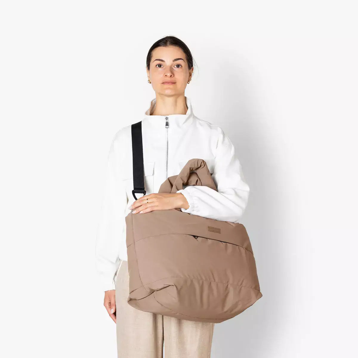 Olivia Medium Moss Earth Shoulder Bag worn by a woman, showcasing style and functionality with multiple pockets.