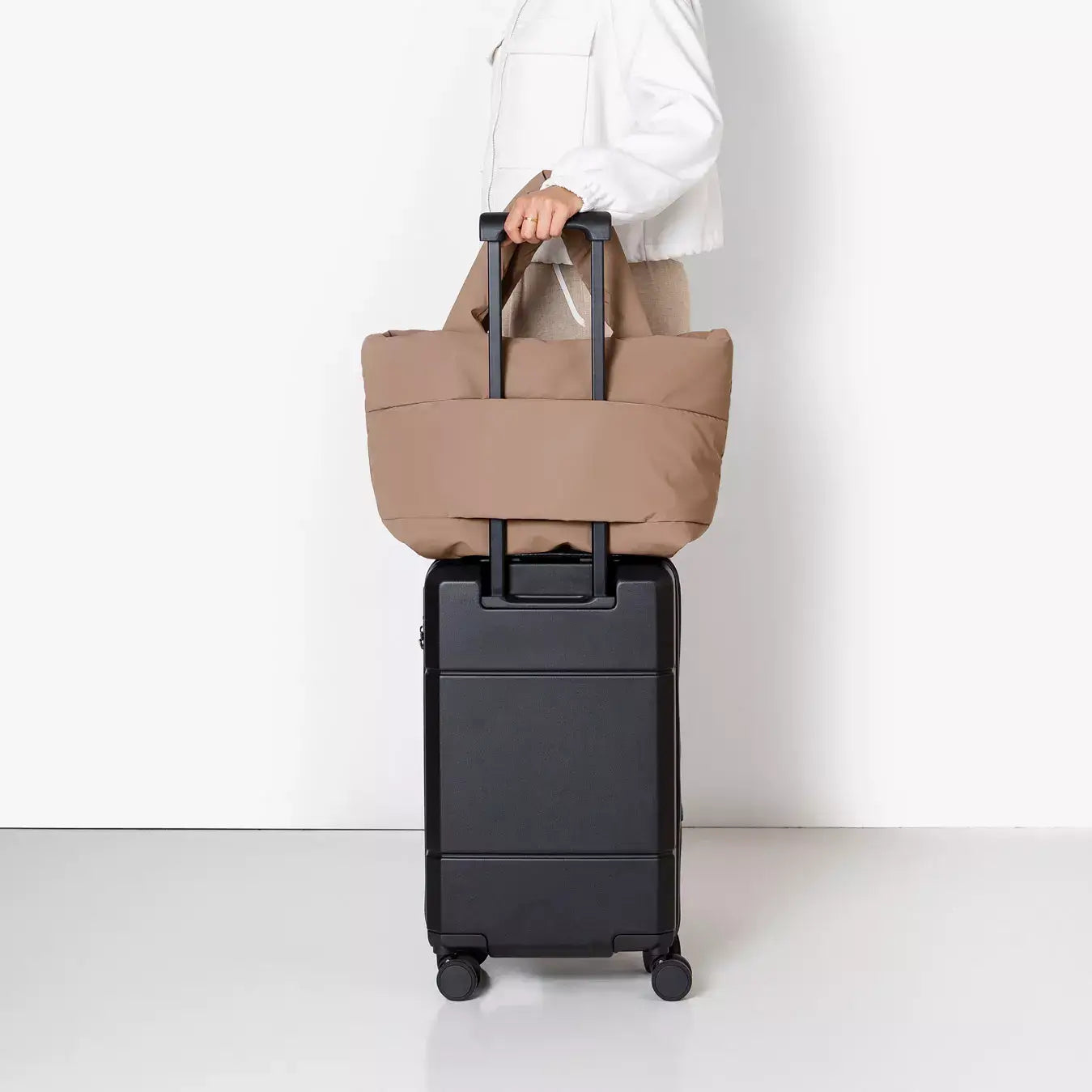 Olivia Medium Moss Earth Shoulder Bag on a rolling suitcase for convenient travel organization.