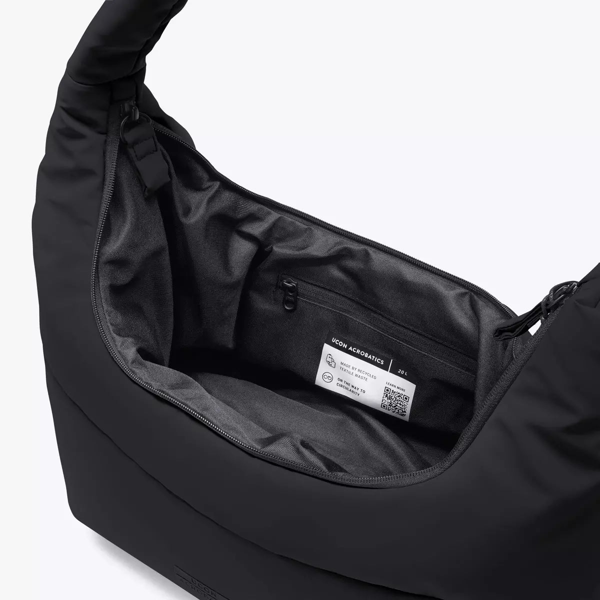 Inside view of the Shota Large Moss Black Shoulder Bag showcasing zipper pocket and spacious compartment.