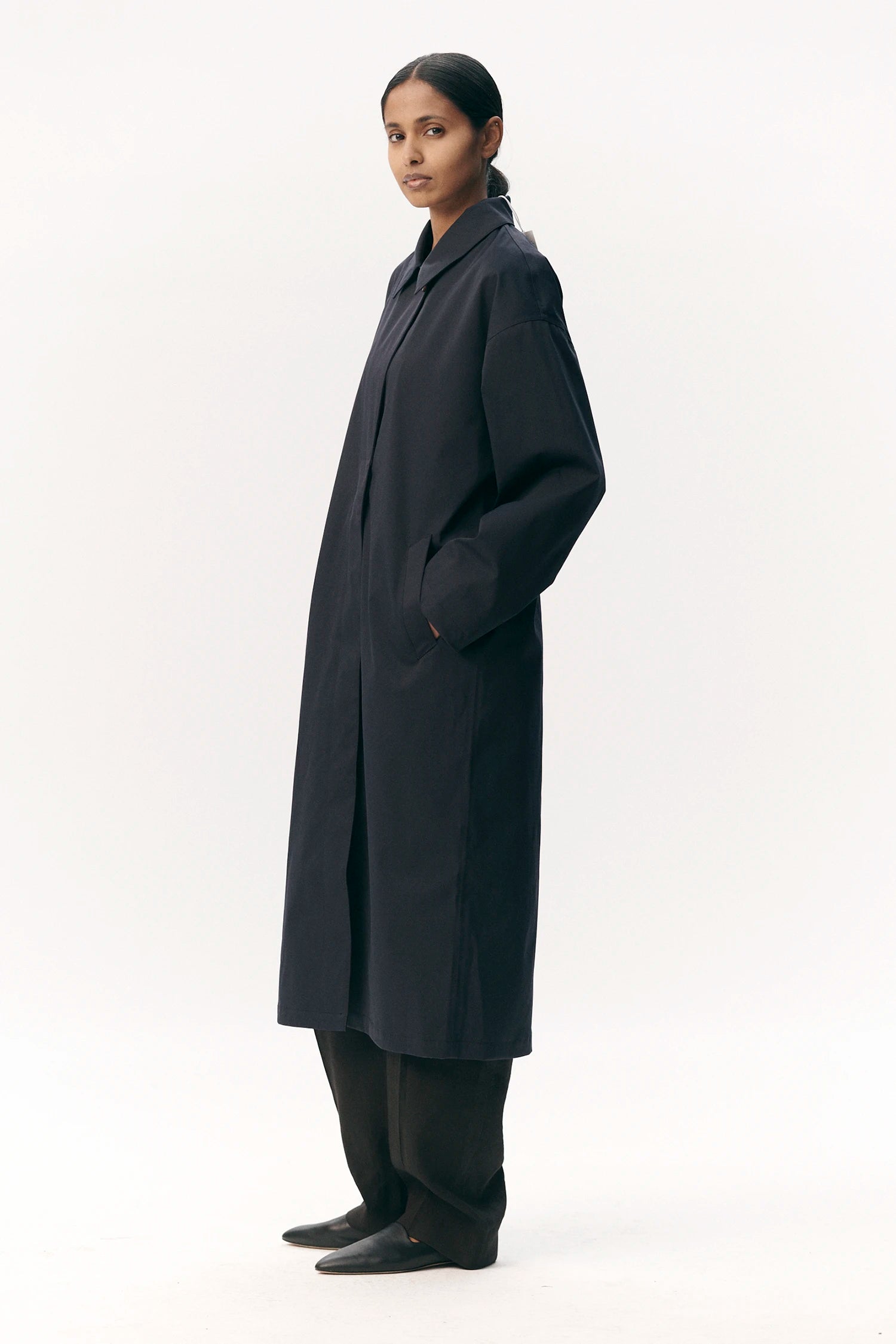 Janice B Navy Coat displayed on a model, showcasing its stylish design and lightweight material.